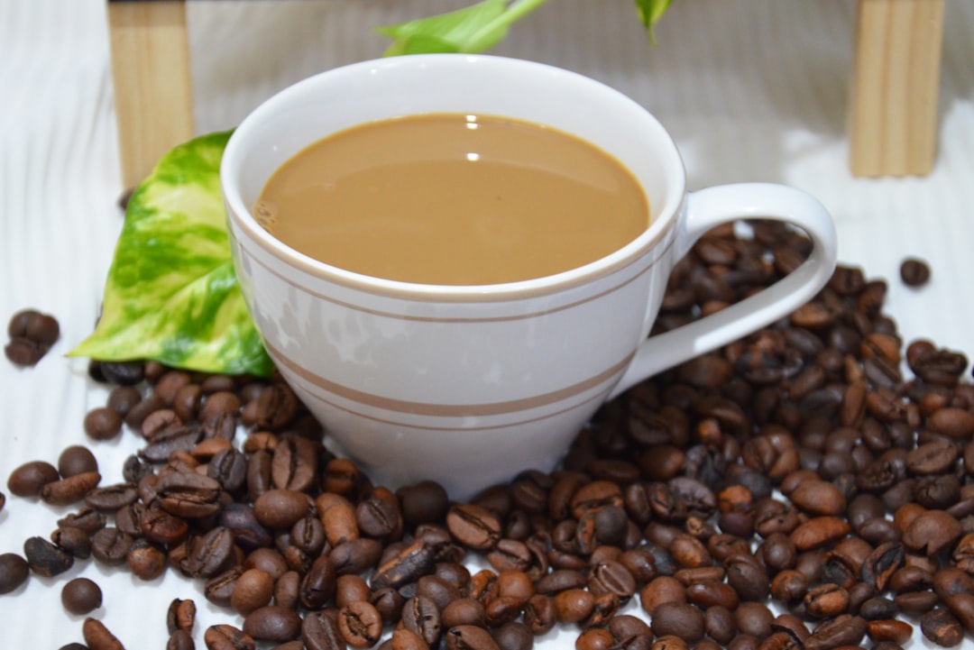 a cup of coffee with coffee beans