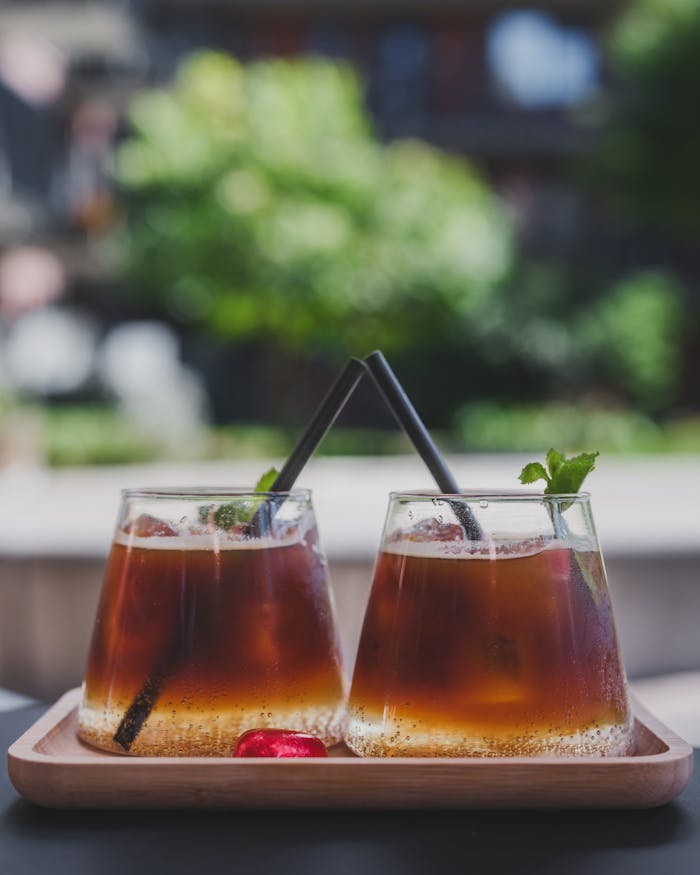 Enjoy a serene afternoon with refreshing cold brew coffee garnished with mint leaves on a sunny terrace.
